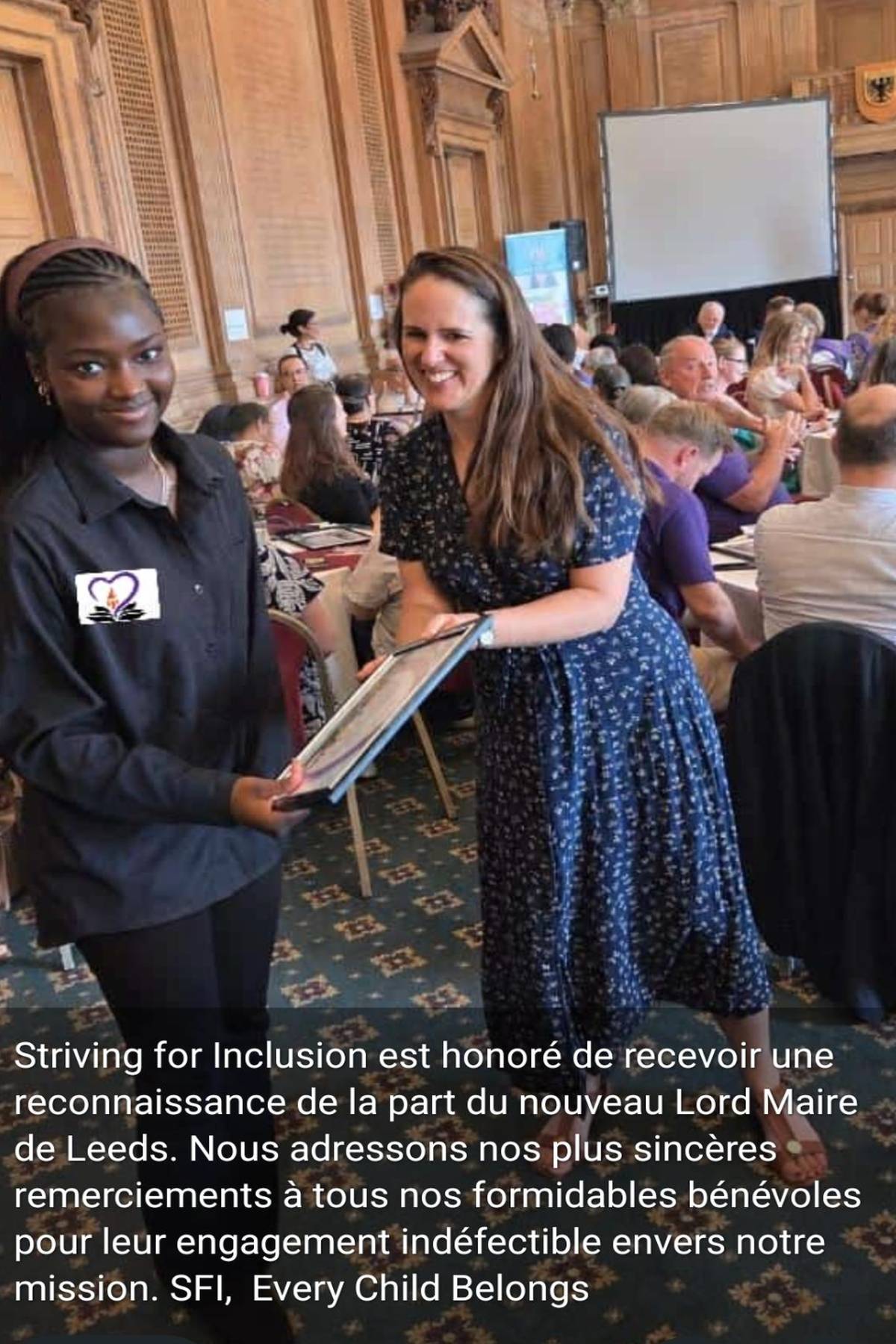 Young volunteer receiving a framed certificate of recognition at a Leeds civic event