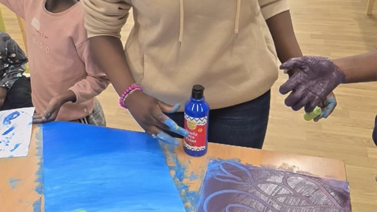 Hands covered in paint during a creative activity