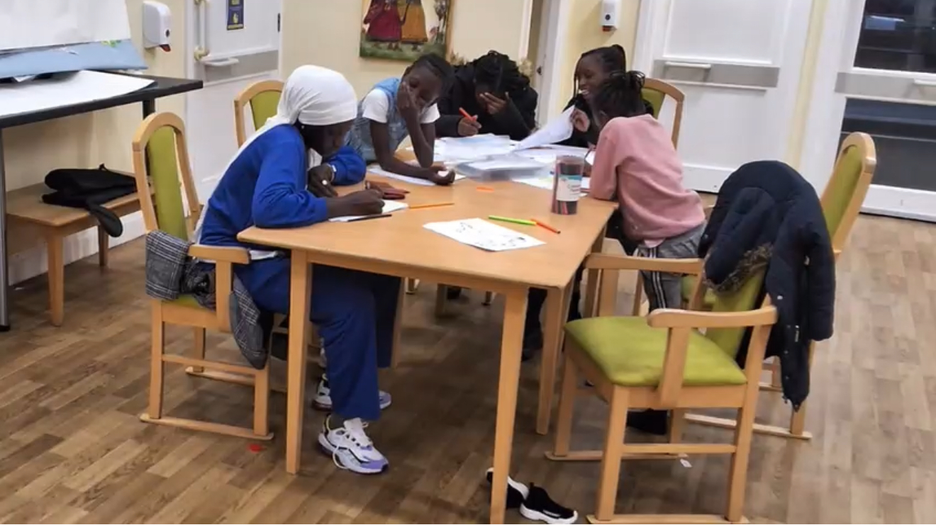 Group of young people working together around a table